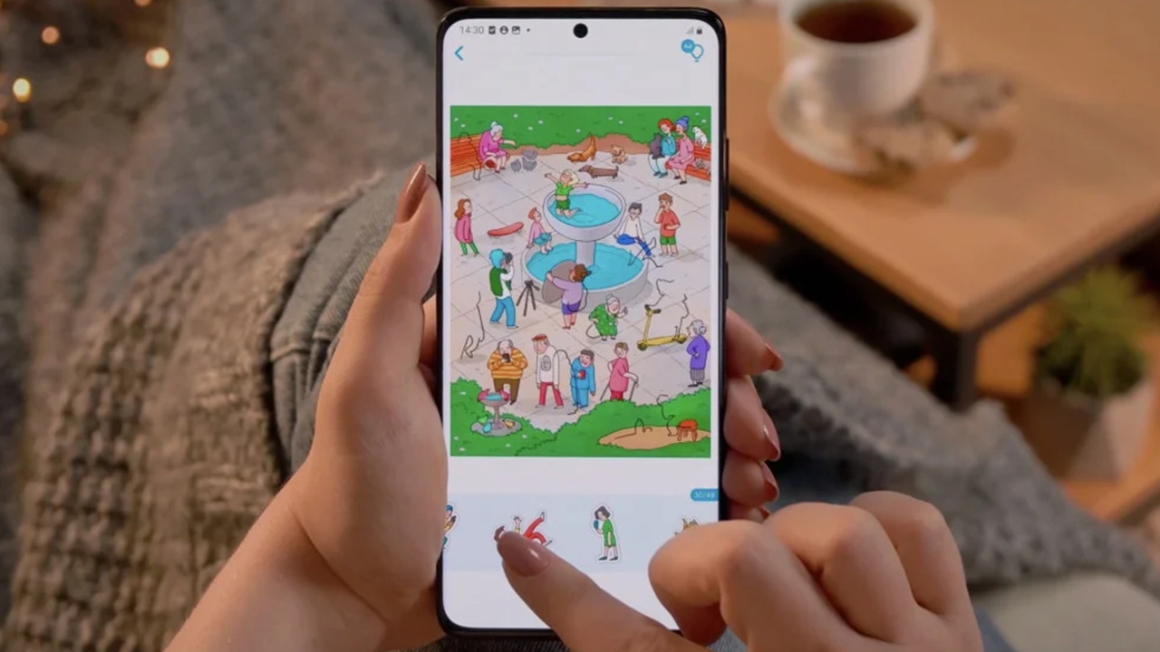 A person holding a smartphone while playing an Easybrain title A person holding a smartphone while playing an Easybrain title