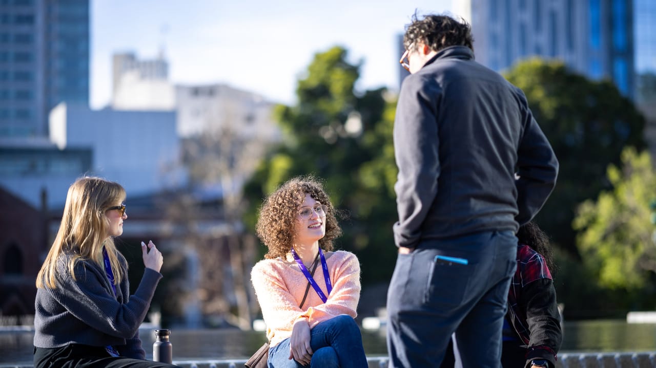 Three people chat by a fountain at GDC Three people chat by a fountain at GDC
