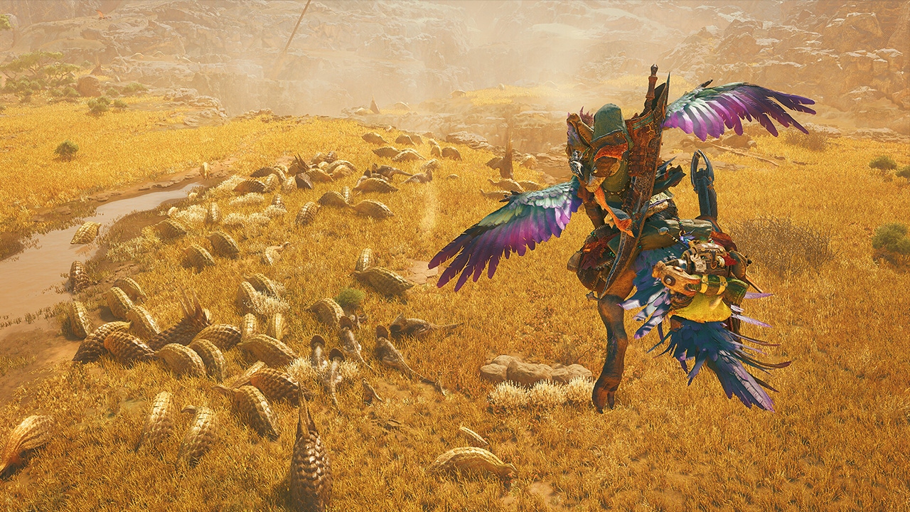 A screenshot from Monster Hunter Wilds showing a player gliding above a herd of creatures A screenshot from Monster Hunter Wilds showing a player gliding above a herd of creatures