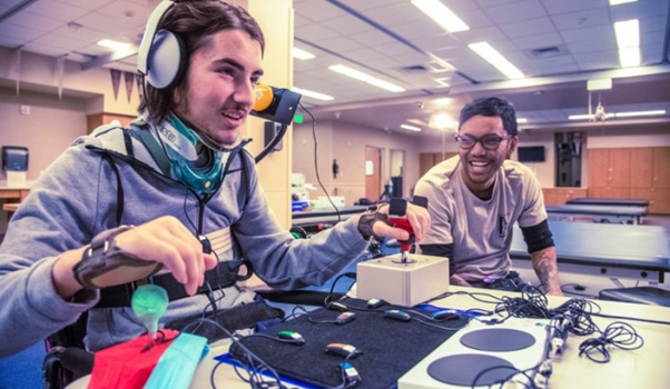Gamer using a complex custom controller setup, based around an Xbox Adaptive Controller