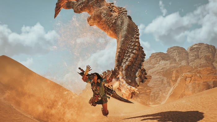 A player character dives to dodge a worm creature in Monster Hunter Wilds.