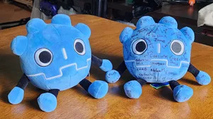 Two plush Godot mascots. One has a number of names sharpied on it. Two plush Godot mascots. One has a number of names sharpied on it.