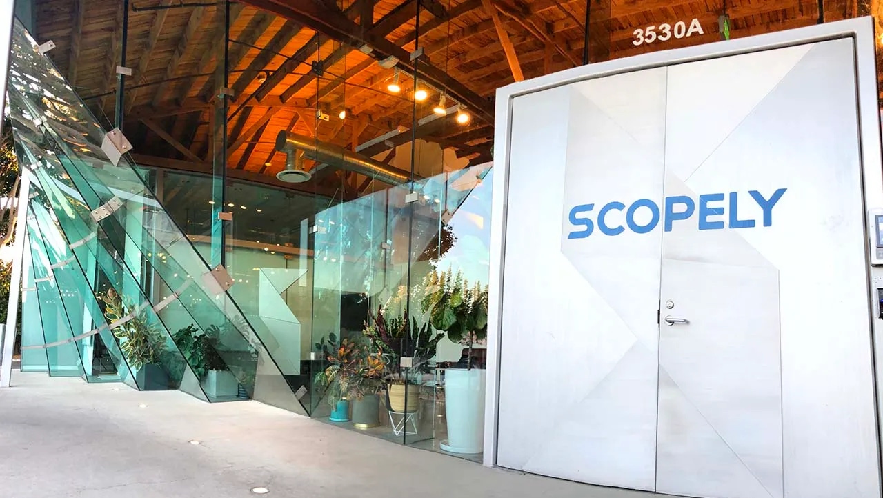 Logo for free-to-play game publisher Scopely spread across an elevator. Logo for free-to-play game publisher Scopely spread across an elevator.