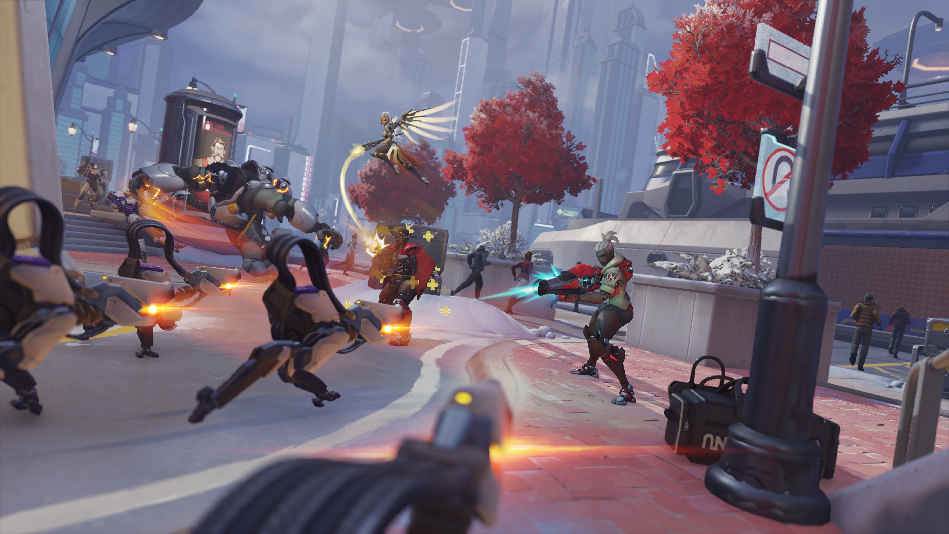 A screenshot from Overwatch 2's story mode. Mercy and Sojourner fend off a wave of Omnic robots.