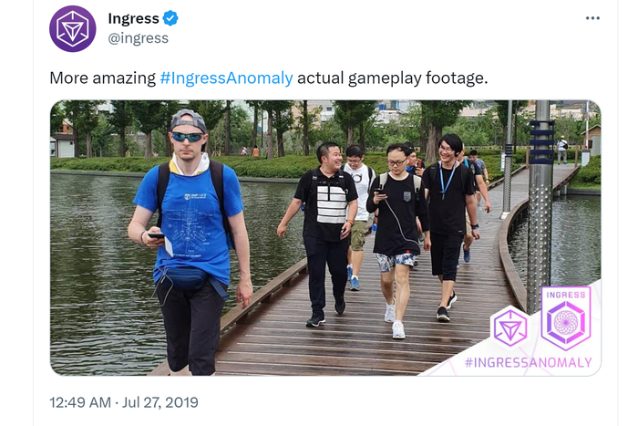 A screenshot of a Tweet from the official Ingress account, depicting a group of players enjoying the game outdoors.
