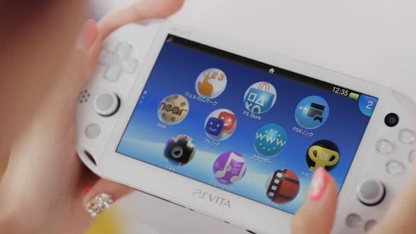 A photograph of the PlayStation Vita in the hands of a player