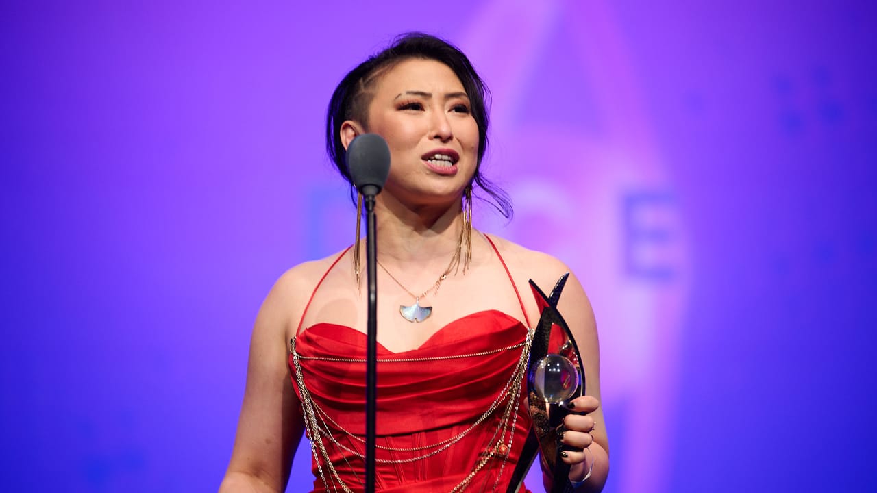 Actor Erika Ishii holds a DICE Award. Actor Erika Ishii holds a DICE Award.