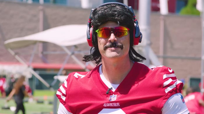Dr Disrespect, in his trademark sunglasses, fake moustache, and wig, in a San Francisco 49ers outfit.