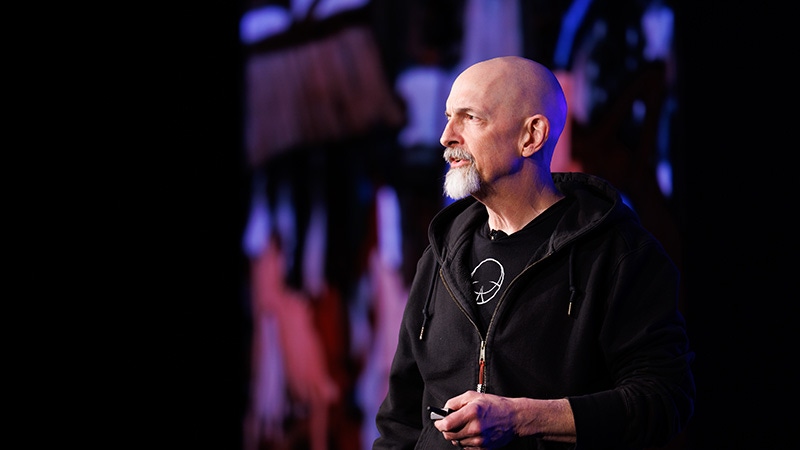 Neal Stephenson stares down at the camera while standing in a cornfield. Neal Stephenson stares down at the camera while standing in a cornfield.