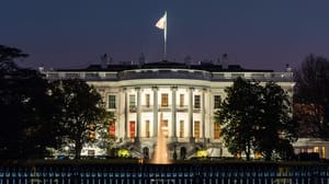 A photograph of The White House at night. A photograph of The White House at night.