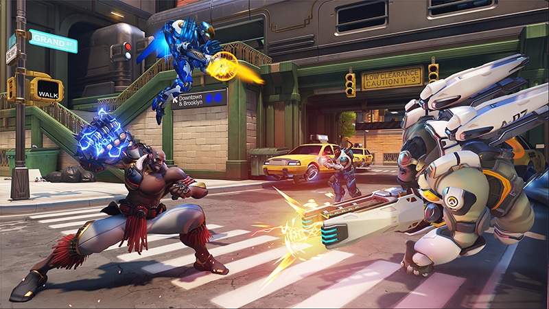 A screenshot from Overwatch two. Four heroes face off on a city street.