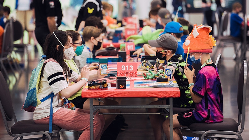 A group of children play The Pokemon Card Game. A group of children play The Pokemon Card Game.