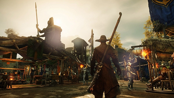 A screenshot from New World. A player character stands in a fantasy market, looking up at a statue.