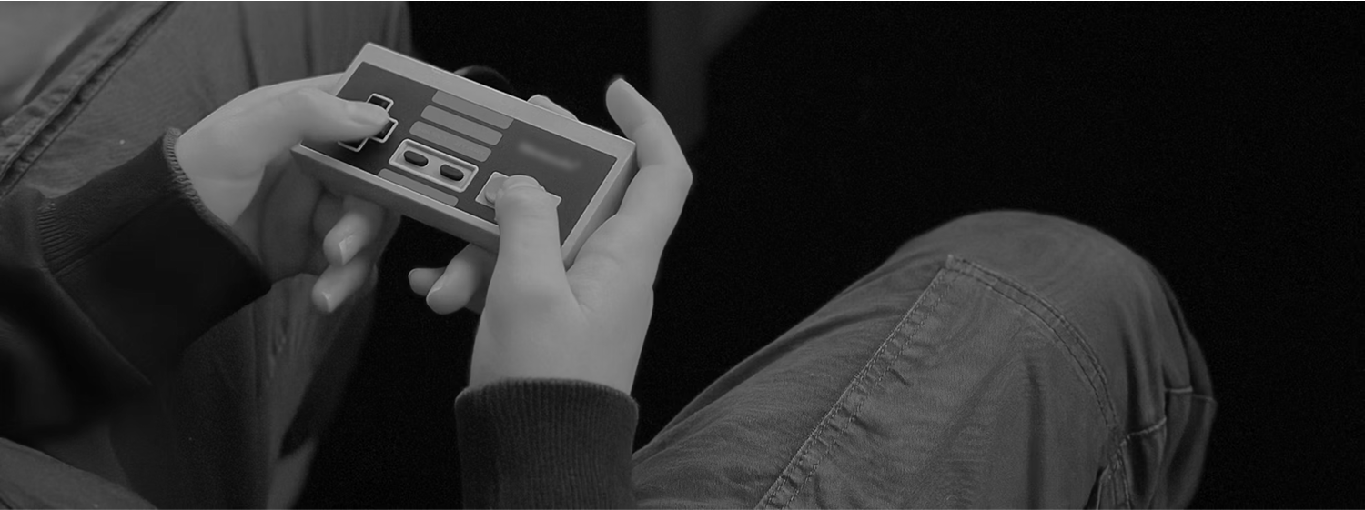 A person holds an NES controller.
