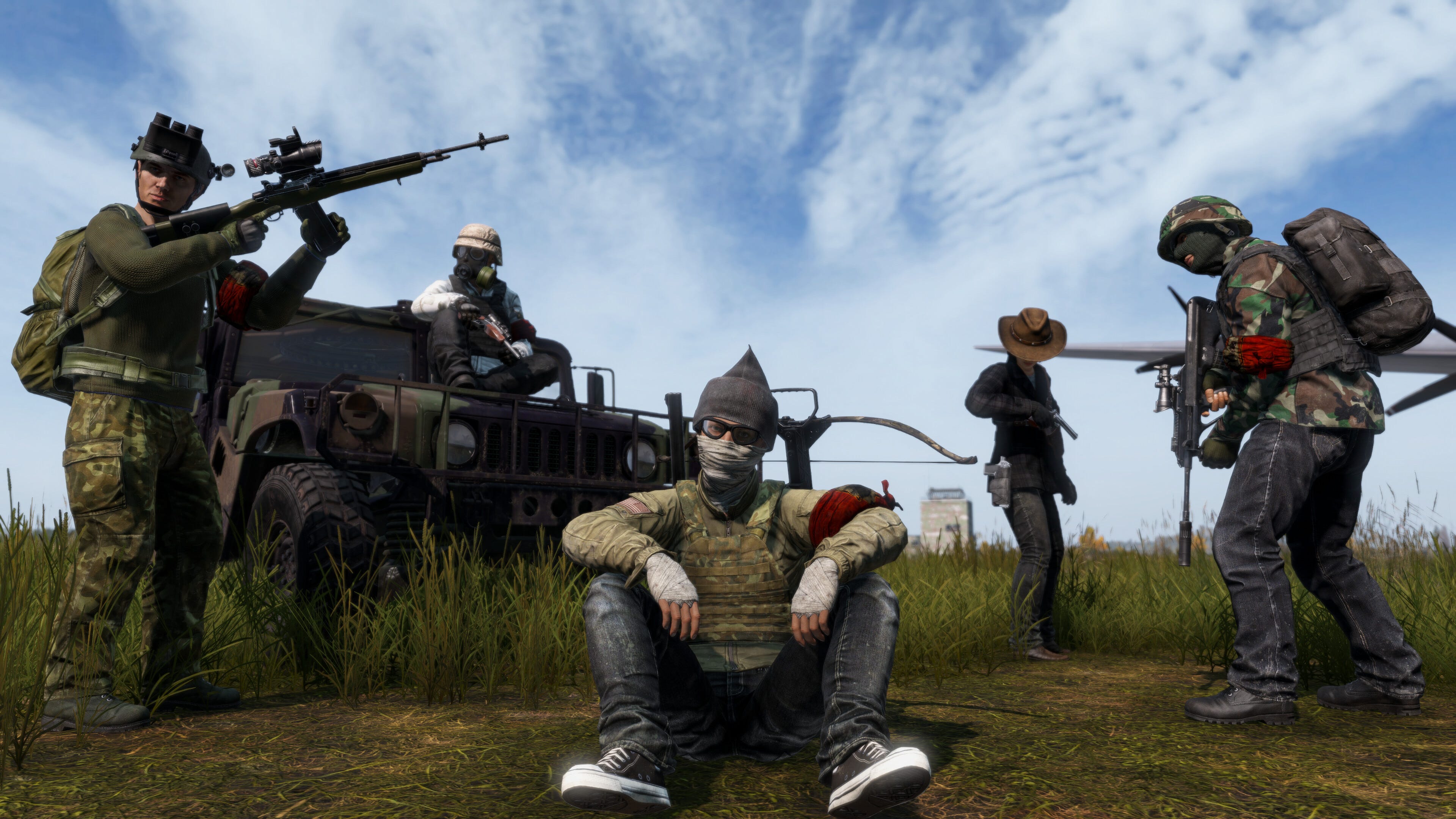 A screenshot from DayZ. A group of players in combat gear strike a pose in front of a jeep. A screenshot from DayZ. A group of players in combat gear strike a pose in front of a jeep.