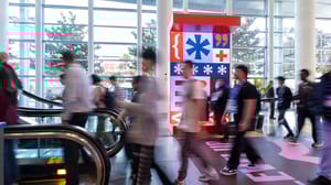 Blurred figures pass through the halls of Moscone West as GDC signage lingers in the background. Blurred figures pass through the halls of Moscone West as GDC signage lingers in the background.