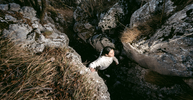 A model wearing Adidas and Terrex hoodie while hiking A model wearing Adidas and Terrex hoodie while hiking