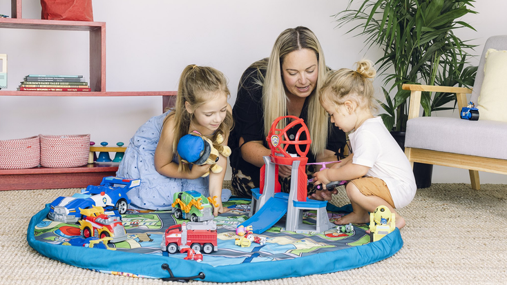 Family playing with the “PAW Patrol” Play Pouch. Family playing with the “PAW Patrol” Play Pouch.
