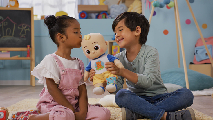 Children playing with "CoComelon" JJ doll. Children playing with "CoComelon" JJ doll.