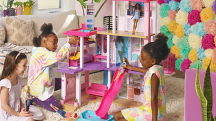 Children playing with a Barbie DreamHouse.