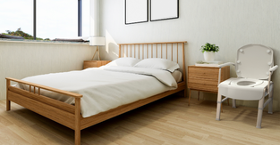 A mockup of what the 3-in-1 comfort commode would look like in a bedroom