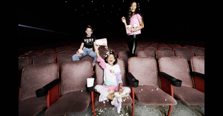 Three young kids wearing apparel and shoes from the PUMA and L.O.L. Surprise! collection