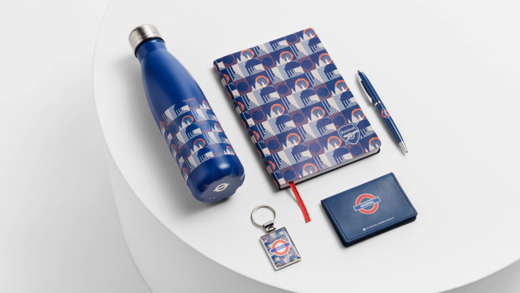 Tfl-branded products including a notebook, water bottle, pen, keychain and wallet.