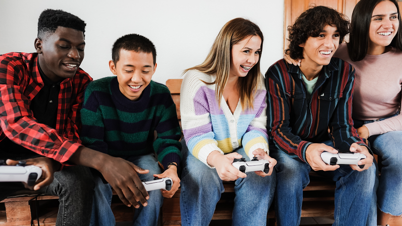 Friends having fun playing video games at home, DisobeyArt, GettyImages, iStock