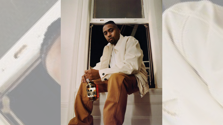 Nas holding the limited-edition V.S bottle. Nas holding the limited-edition V.S bottle.