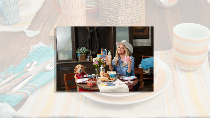 Miranda Lambert, alongside her dog, surrounded by products from the Wanda June collection.