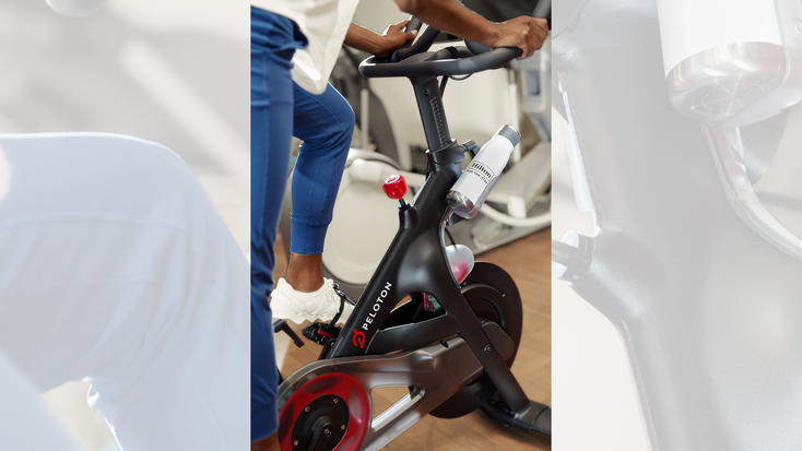A Hilton guest working out on Peloton equipment with a Hilton-branded water bottle. A Hilton guest working out on Peloton equipment with a Hilton-branded water bottle.
