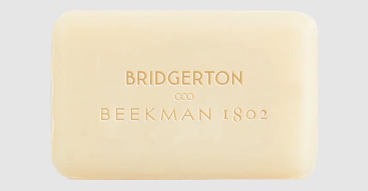 A bar of soap with the Beekman 1802 logo and the "Bridgerton" logo A bar of soap with the Beekman 1802 logo and the "Bridgerton" logo