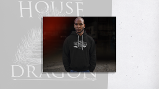 Model wearing a hoodie with “Dreams Didn’t Make Us Kings, Dragons Did," quote.