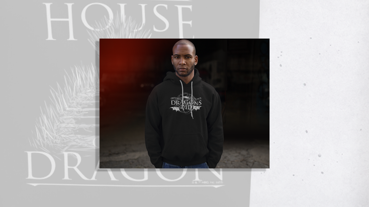 Model wearing a hoodie with “Dreams Didn’t Make Us Kings, Dragons Did," quote. Model wearing a hoodie with “Dreams Didn’t Make Us Kings, Dragons Did," quote.