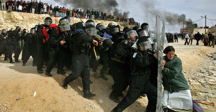  Photo of a Jewish settler challenging Israeli security officers in the West Bank settlement of Amona, Feb. 1, 2006,