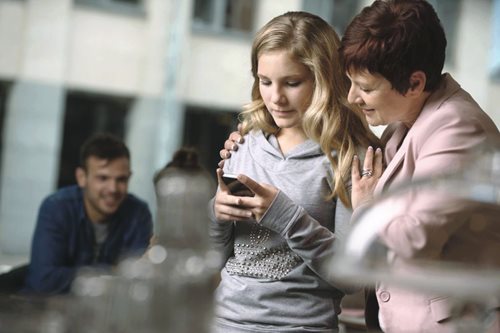 mother-with-daughter-checking-phone.jpg