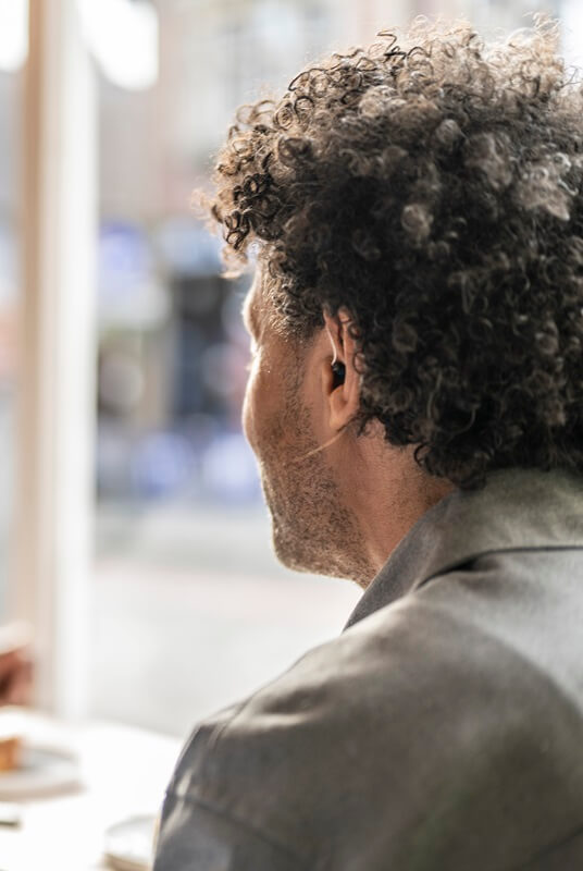 man-wearing-hearing-aid-in-cafe-mobile-banner.jpg
