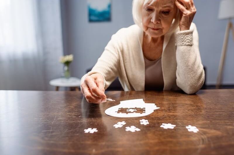 elderly-woman-combining-jigsaw.jpg