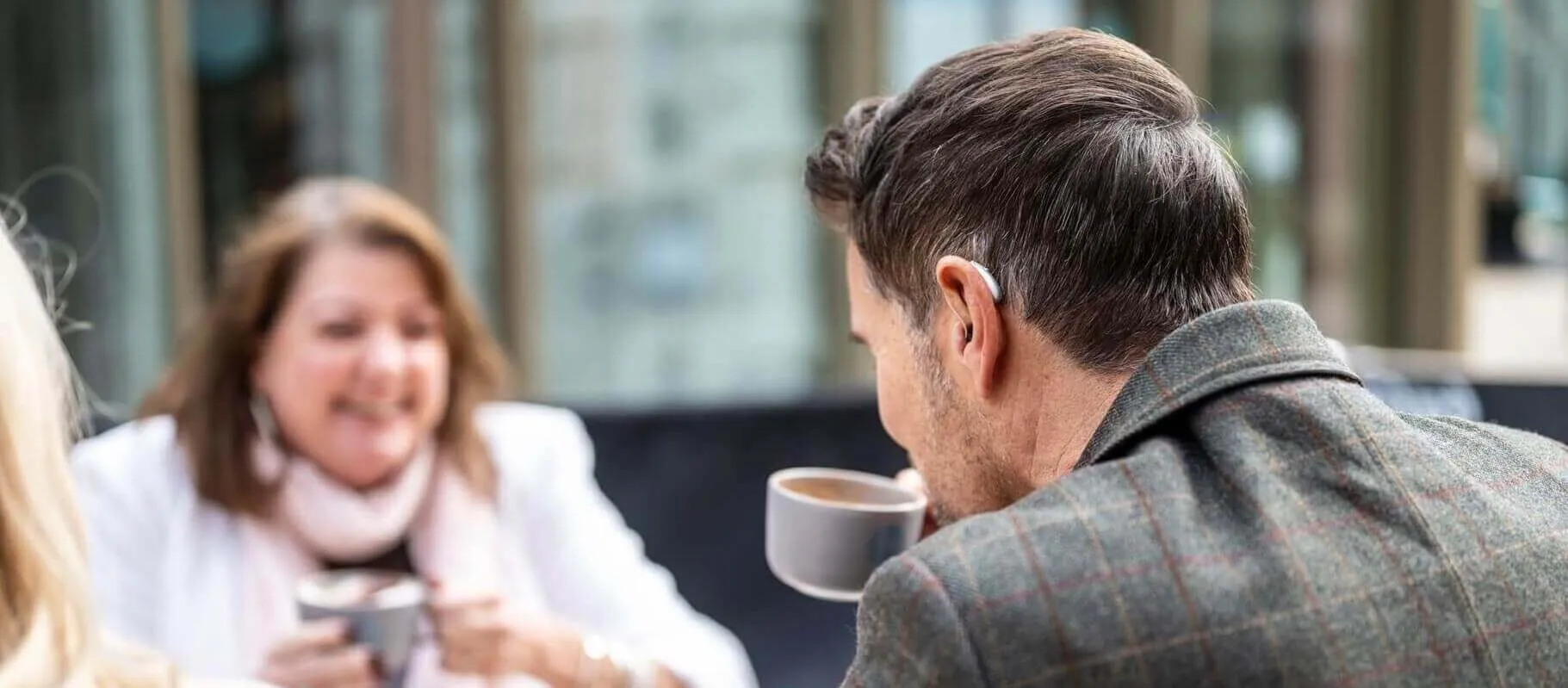 man-drinking-coffee-with-hearing-aid-desktop-banner.jpg