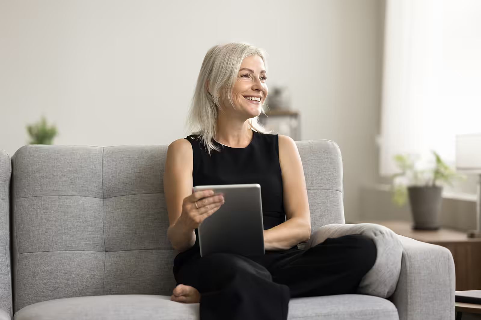 woman with tablet on couch.avif