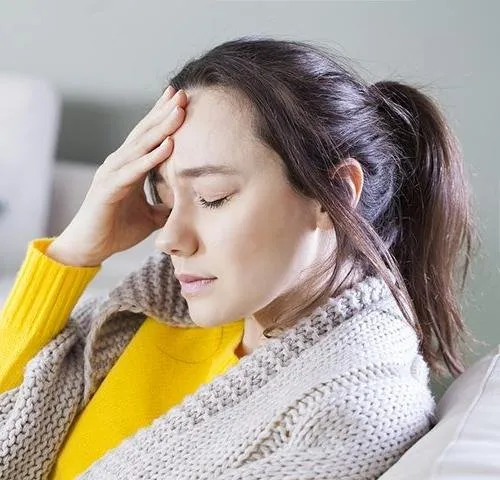bigstock-young-woman-with-headache-sitt-3424296520 .jpg