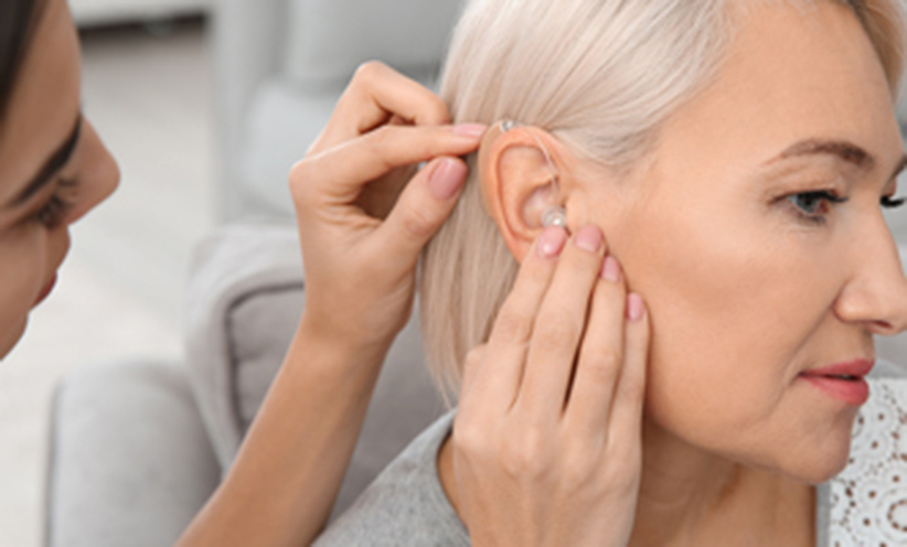 332x300-putting-hearing-aid-in.jpg