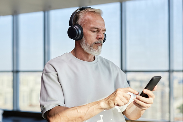 online hearing test man with headphones and phone.jpg