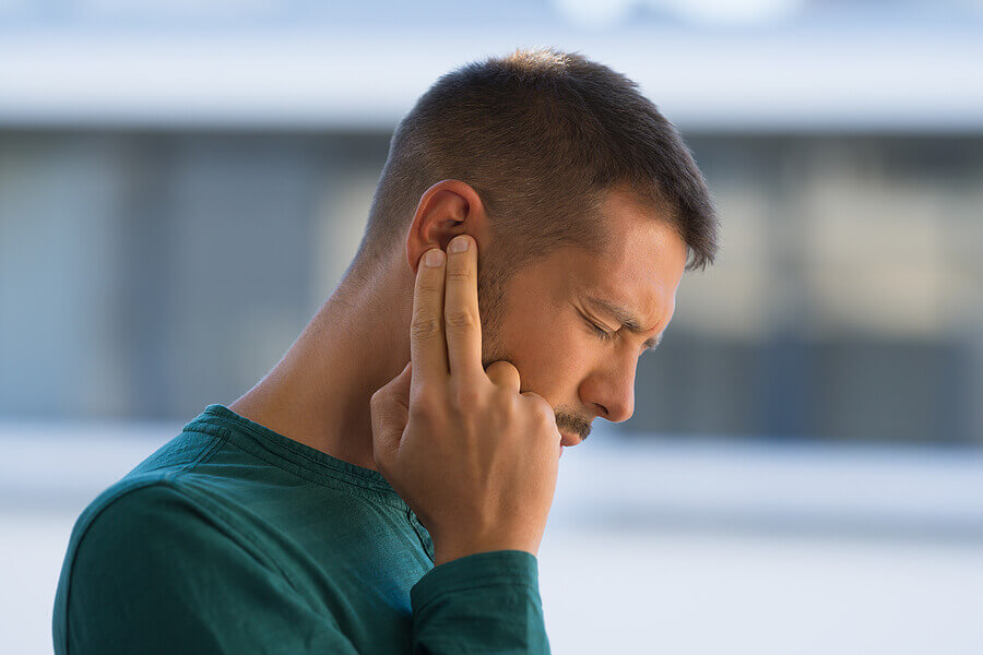 man-with-tinnitus-man-touching-his-ear.jpg