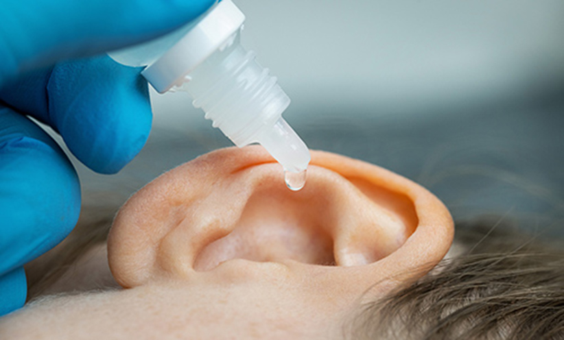 doctor-dripping-ear-drops-into-500.jpg