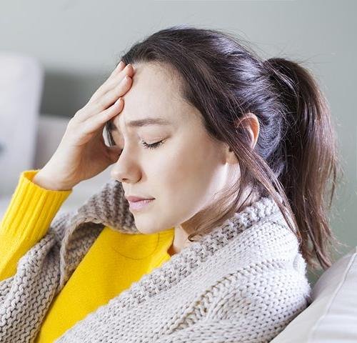 bigstock-young-woman-with-headache-sitt-3424296520.jpg