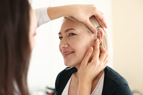 doctor-put-hearing-aid-to-woman-ear-500.jpg