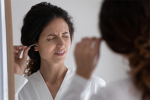 unhappy-woman-clean-ears-500.jpg