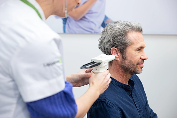 Image of man getting ear mold injection prior to getting hearing aids.
