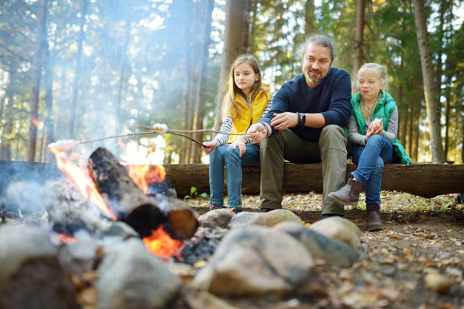 father campfire with daughters.avif